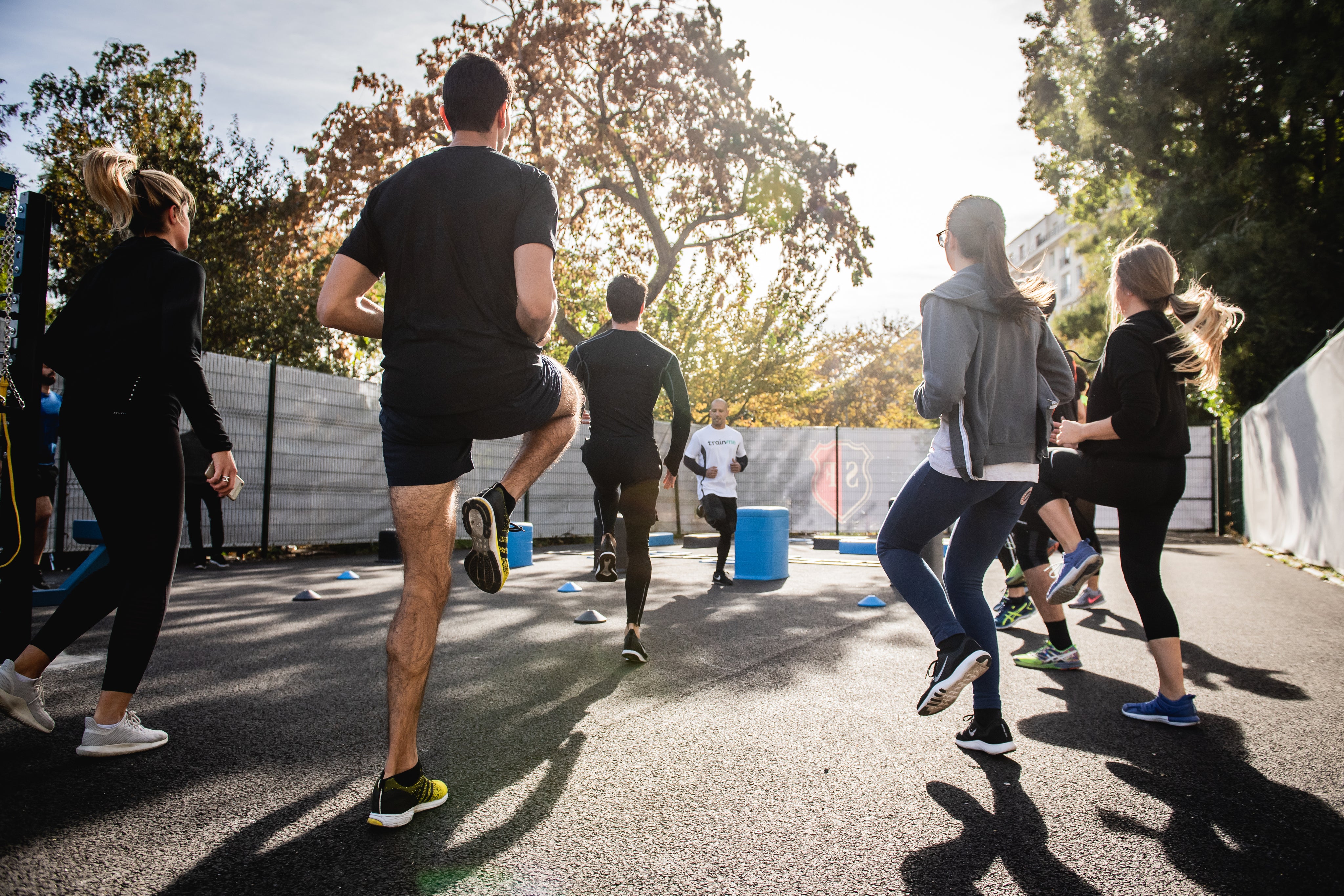 group-of-people-stand-facing-a-fitness-instructor.jpg